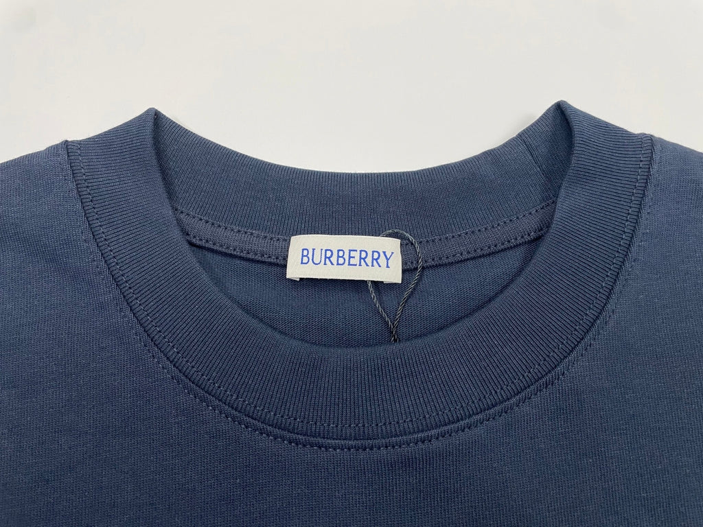 Navy crew-neck T-shirt collar with Burberry label at neckline.