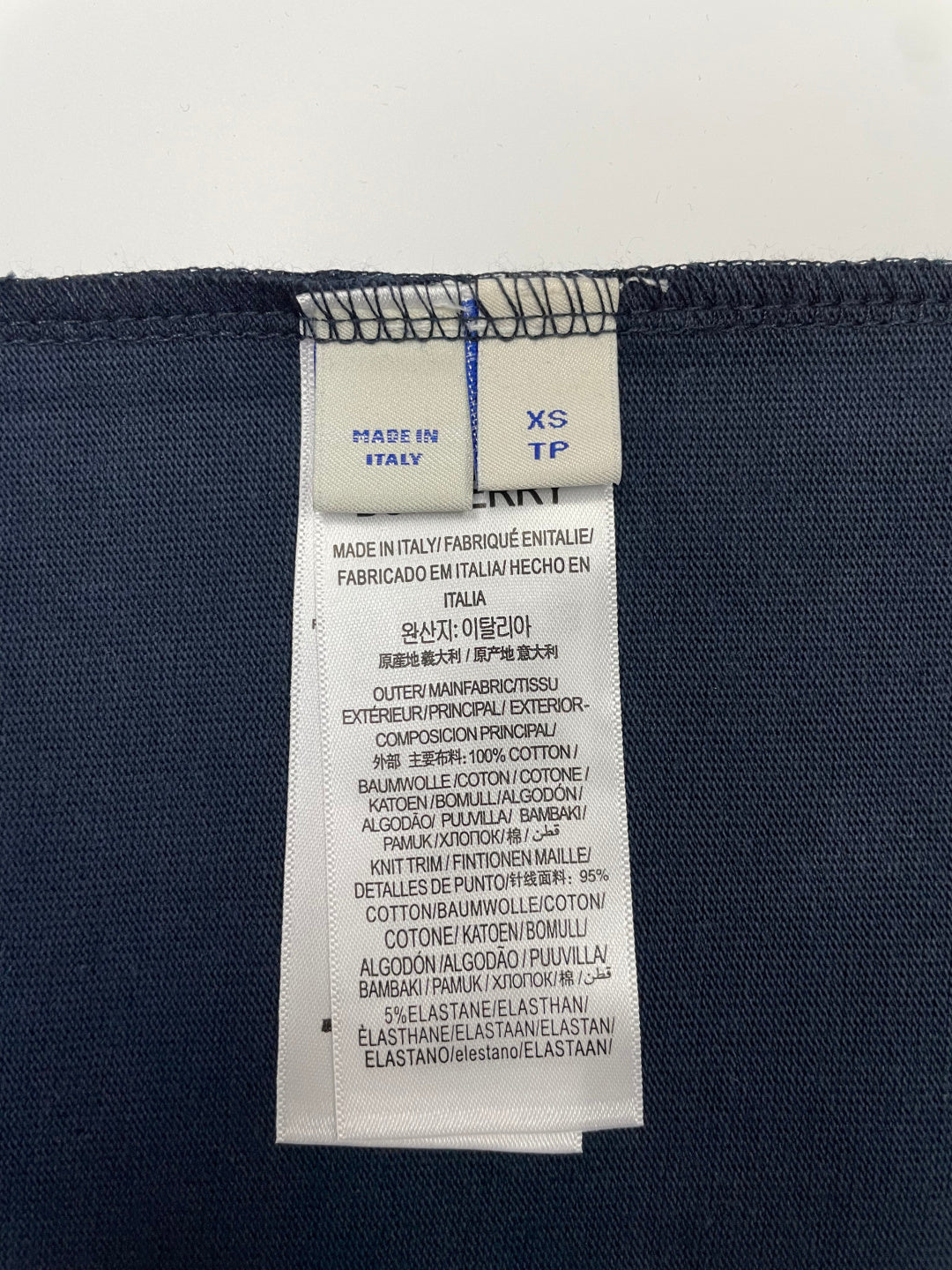 Navy T-shirt size XS TP care label with fabric and made-in details.