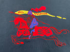 Navy T-shirt with red, blue, and yellow graphic horse-style print.