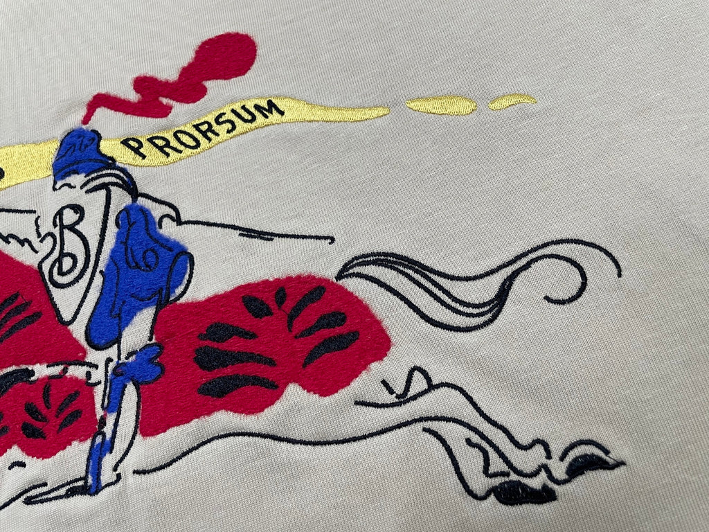 Burberry beige T-shirt close-up with rider graphic and curved lines