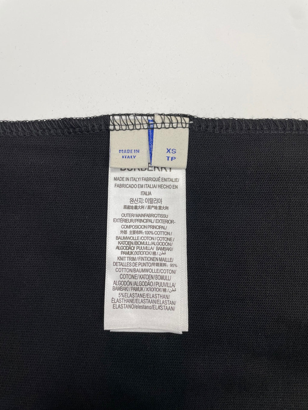 Size and care label inside dark short-sleeve t-shirt, XS
