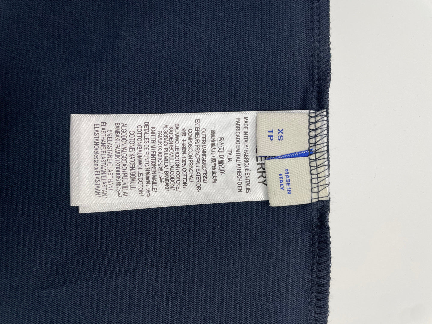 Inside neck size label marked XS on navy T-shirt