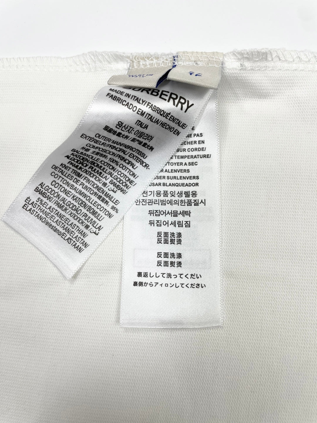 White T-shirt interior care label with washing and material instructions