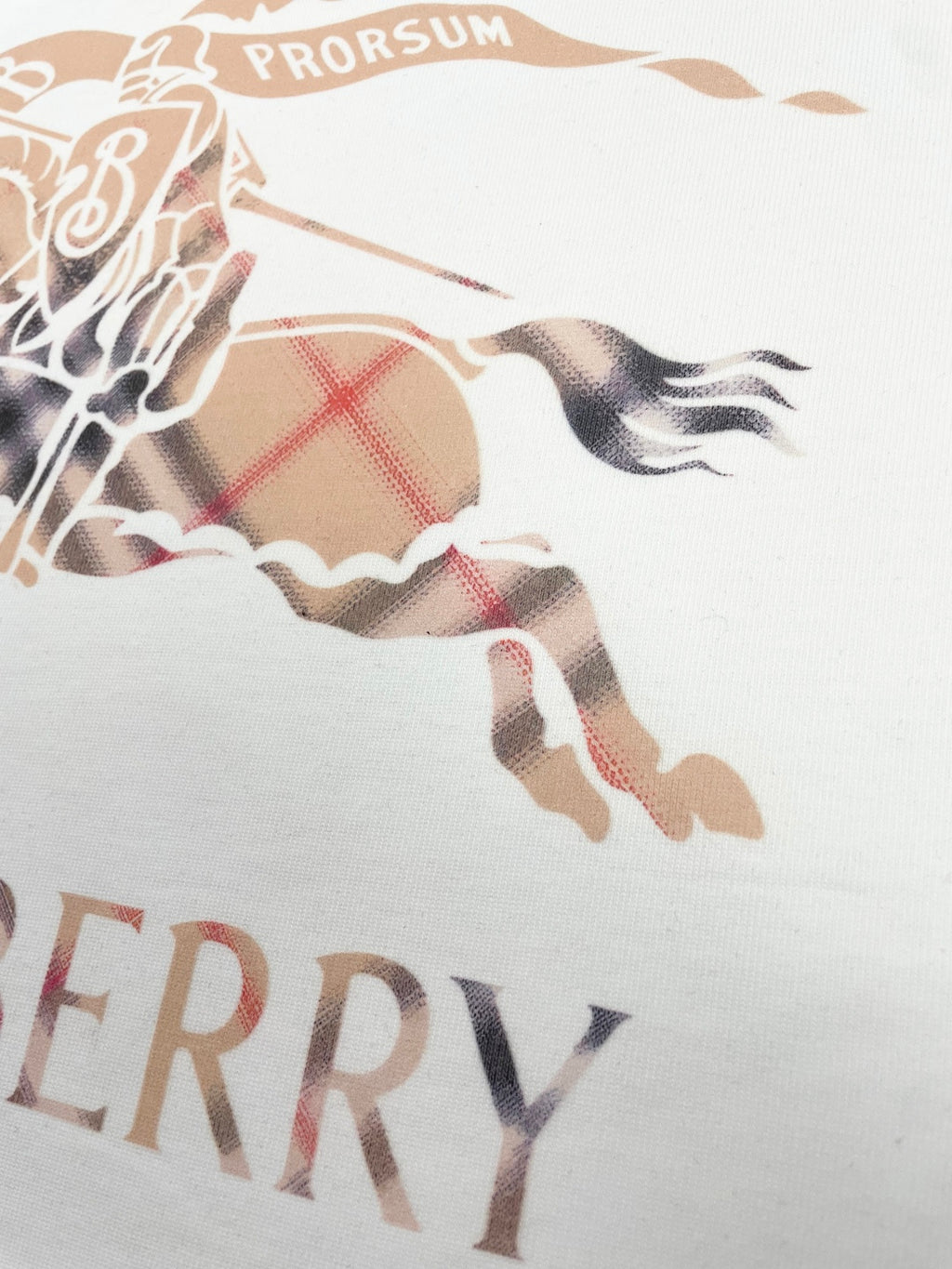Close-up of horse graphic and Burberry text on white T-shirt