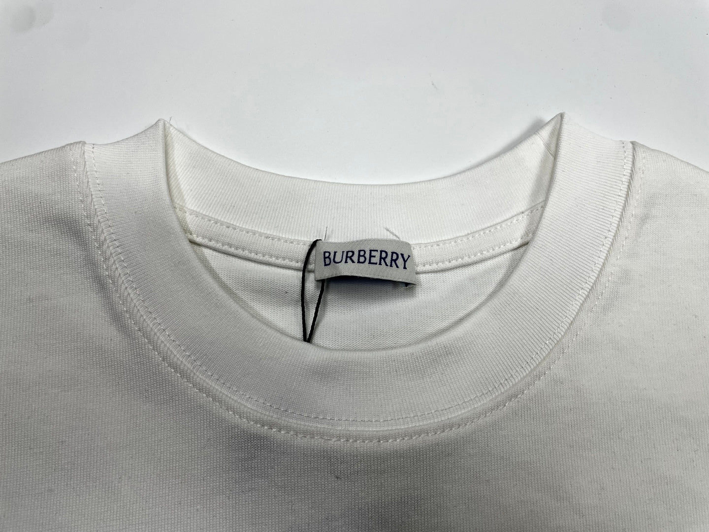 White crew-neck T-shirt collar with stitched Burberry neck label