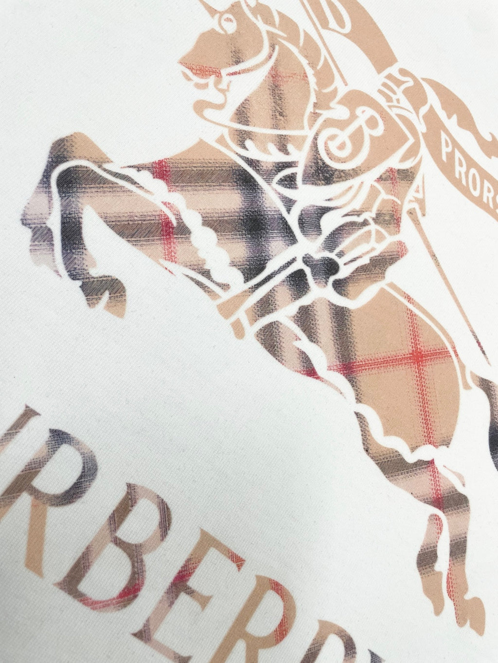 Close-up of horse graphic on white T-shirt with plaid and check pattern
