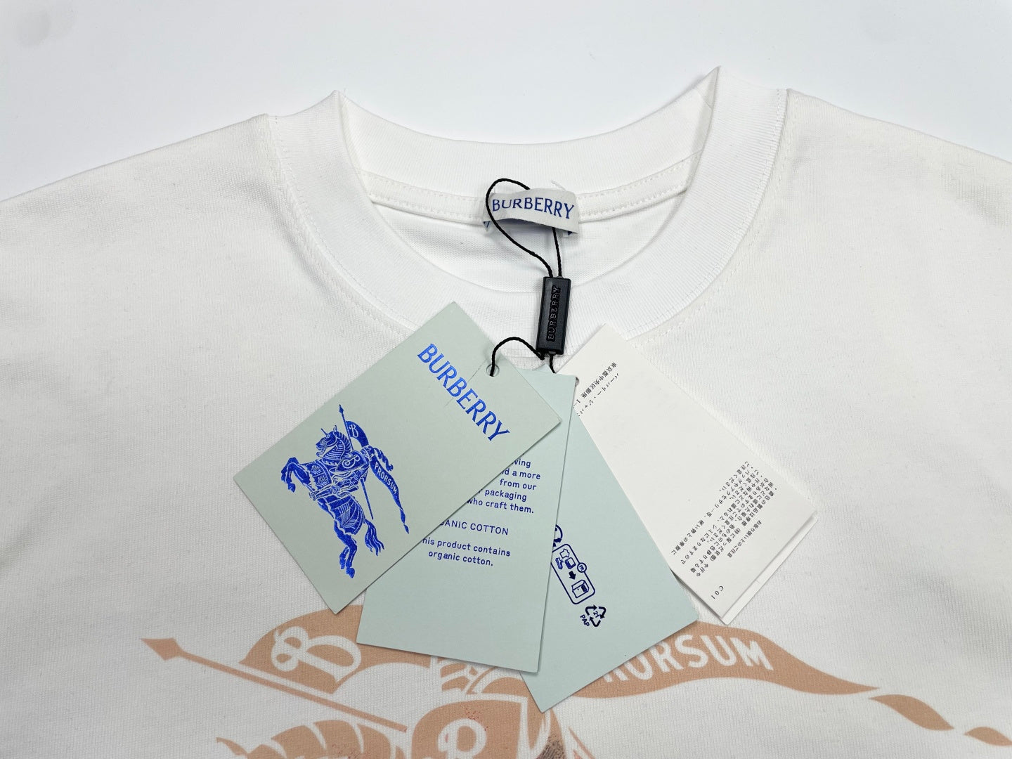 White graphic T-shirt with horse artwork and hang tags at neckline