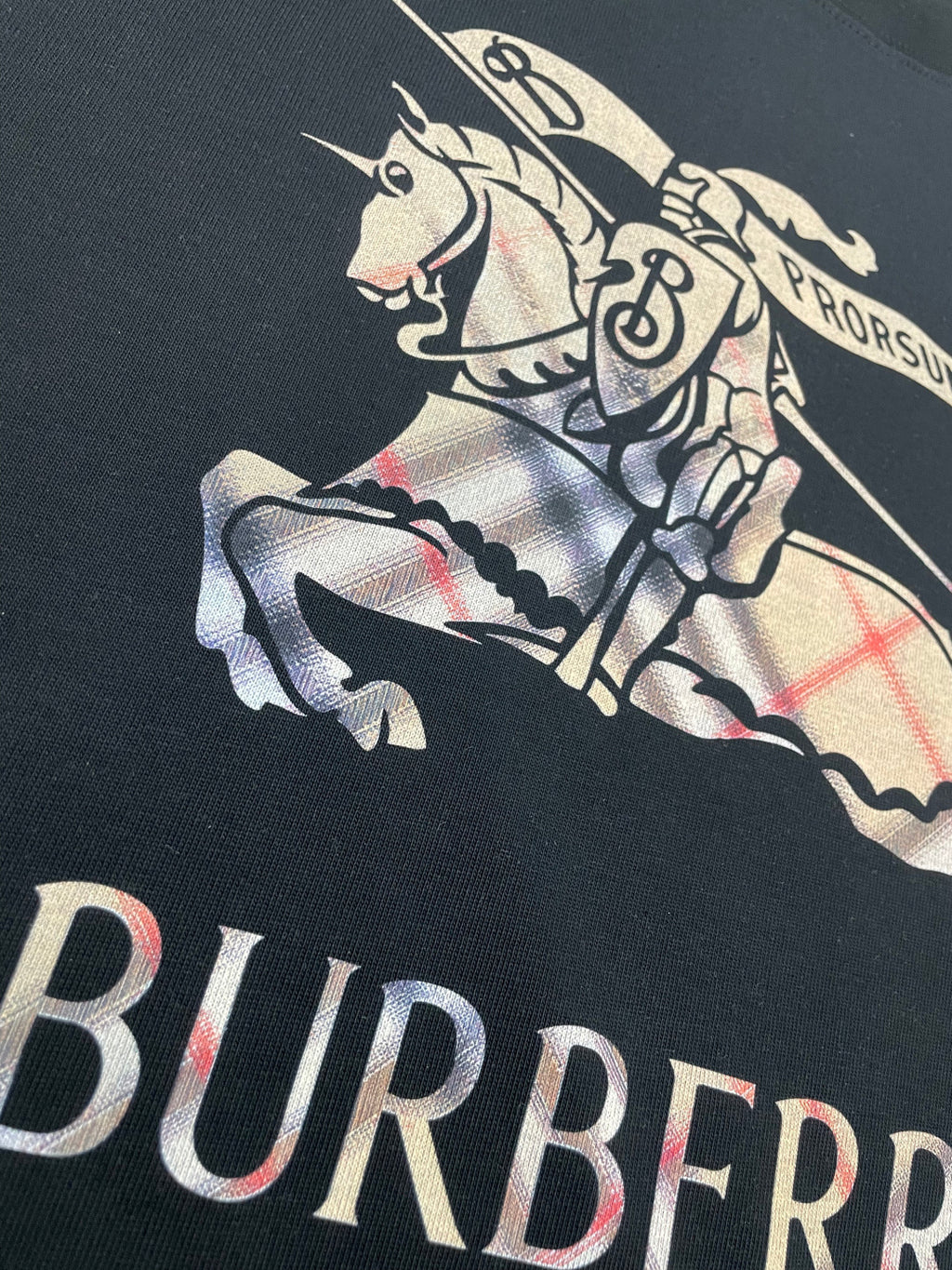 Black T-shirt close-up of horse-and-rider graphic with Burberry lettering