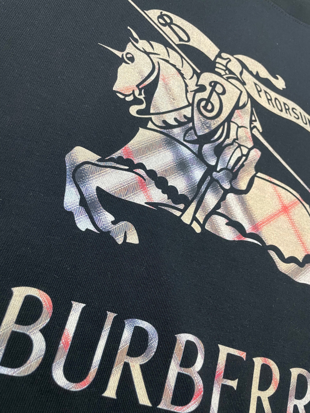 Black T-shirt close-up of horse-and-rider graphic with Burberry lettering