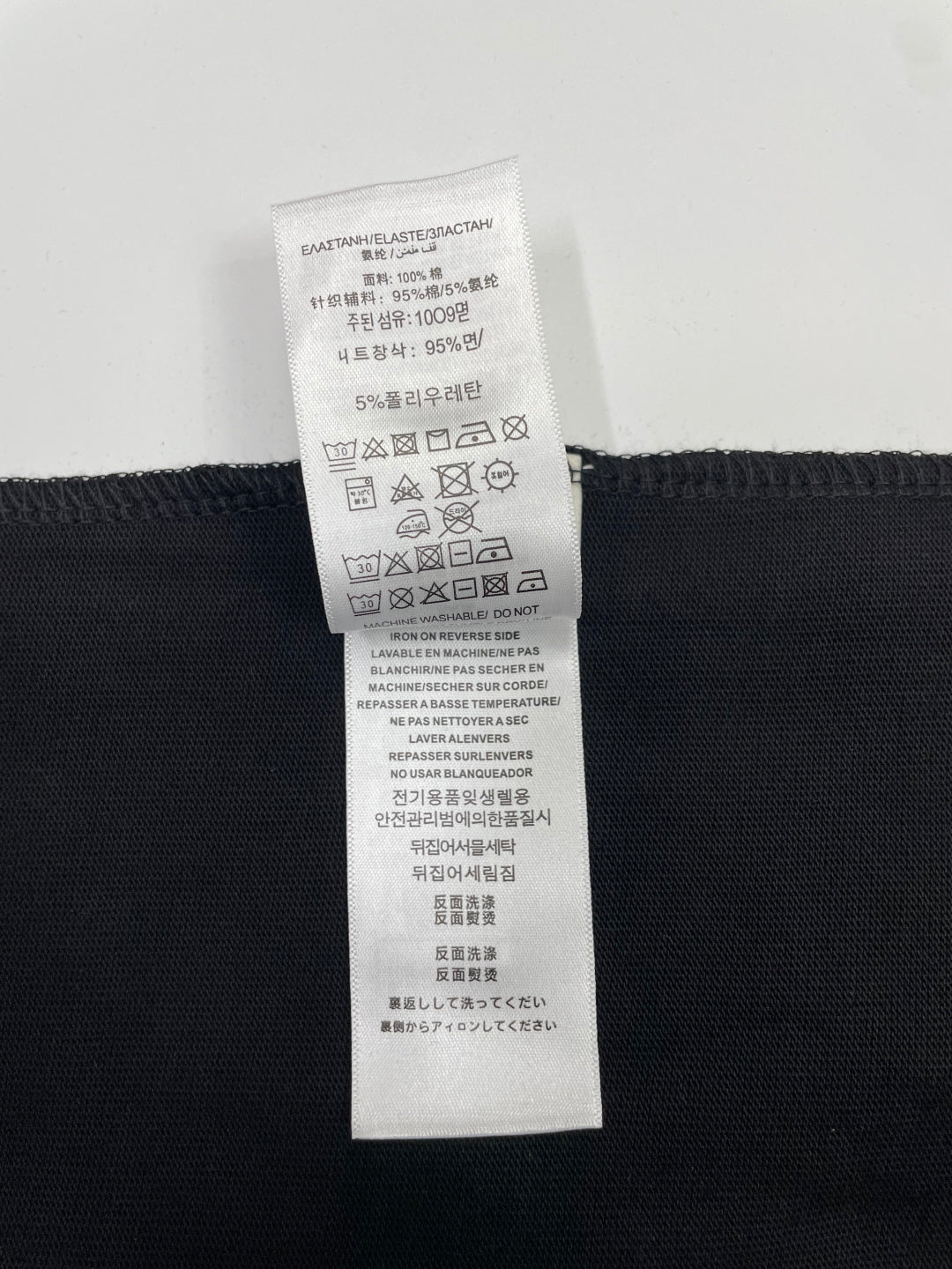 Black Burberry T-shirt care instructions label with fabric composition details