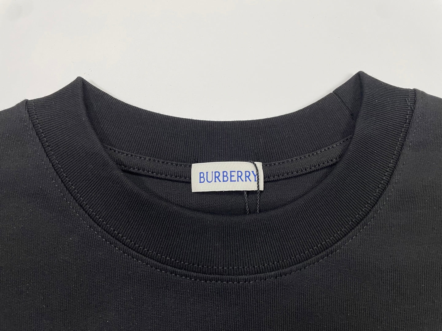 Black short-sleeve T-shirt neckline with Burberry logo tag at collar