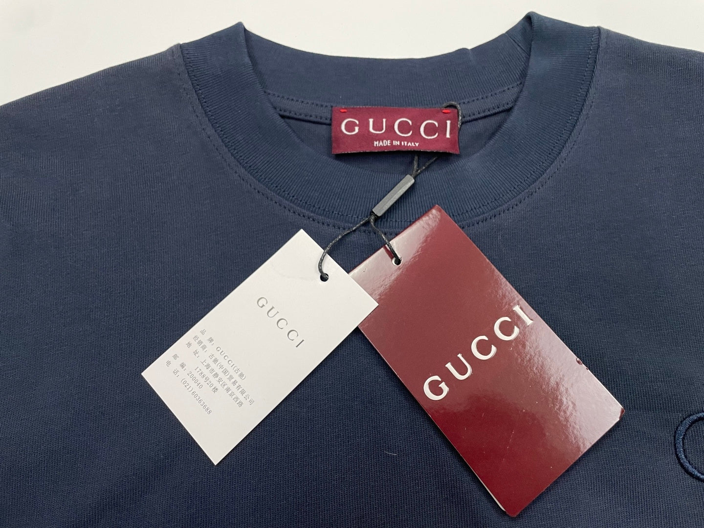 Navy crew-neck T-shirt with hang tags attached