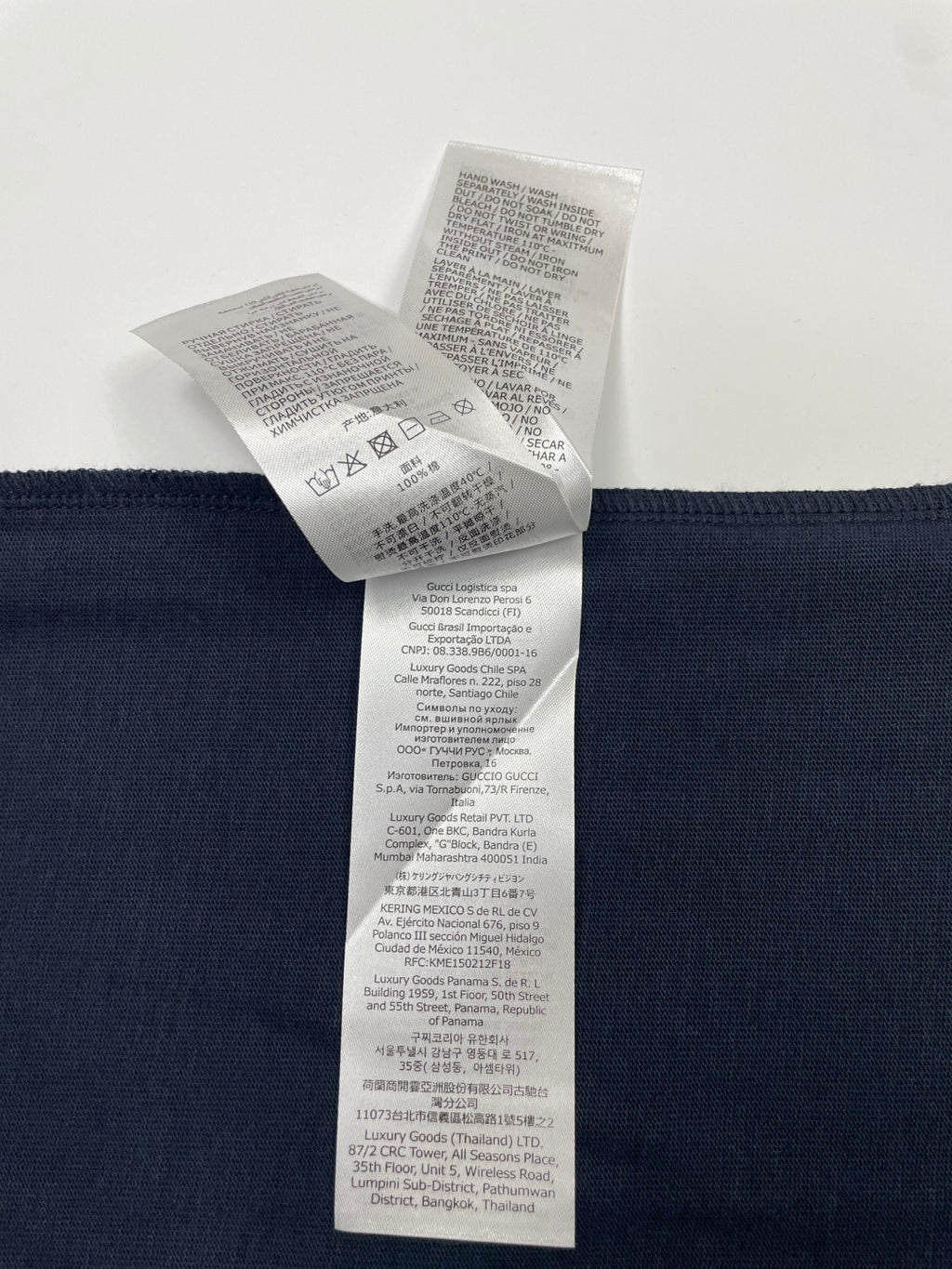 Inside view of navy T-shirt care label attached near waistband