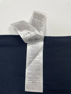 Inside view of navy T-shirt care label attached near waistband