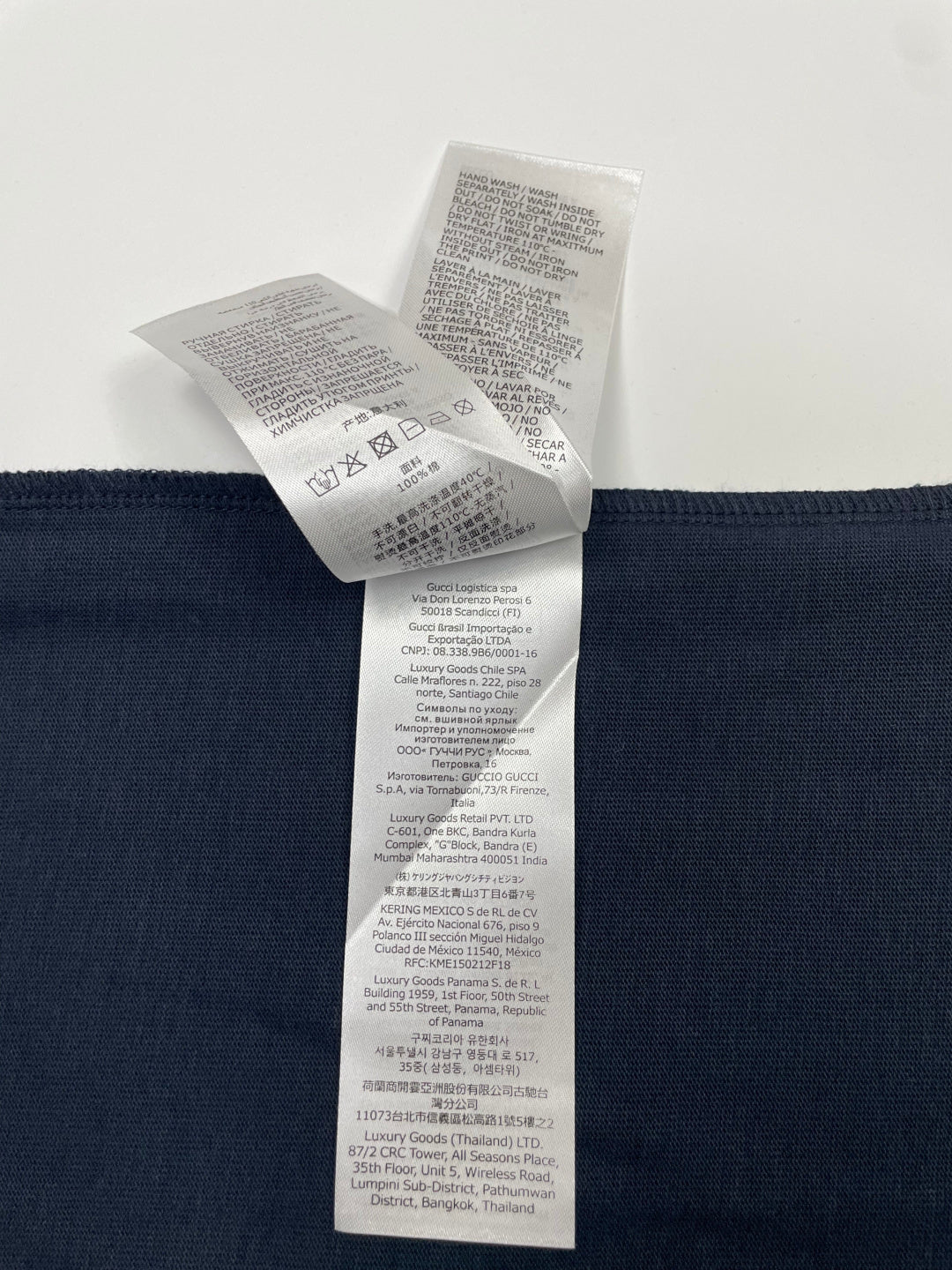 Inside view of navy T-shirt care label attached near waistband
