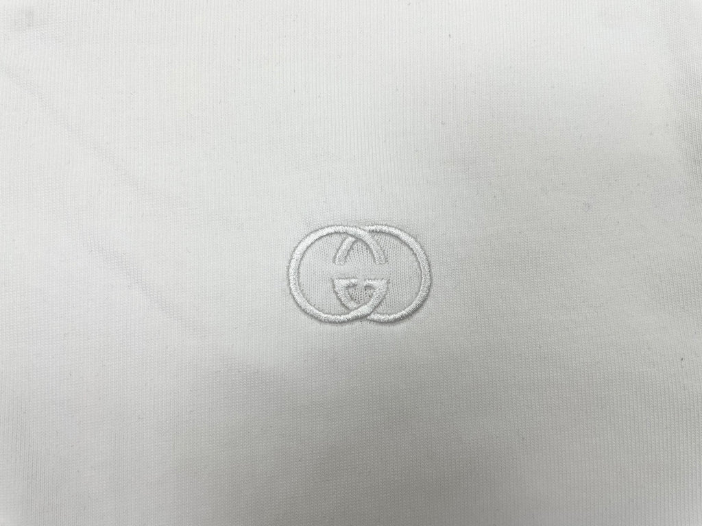 Gucci-style logo embroidery on white T-shirt fabric