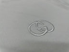 Gucci logo emblem stitch detail on white T-shirt chest