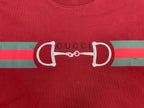 Red T-shirt front with large white horsebit graphic and Gucci lettering