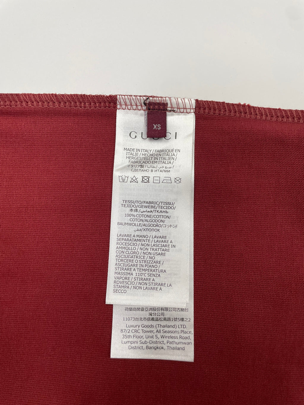 Red T-shirt hem with attached white care label tag