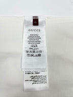White T-shirt size XS label with Gucci and care instructions