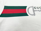 White T-shirt hem with green and red stripe band and horsebit graphic