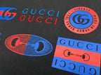 Dark Gucci T-shirt graphic logos, GUCCI text, and stamp patch