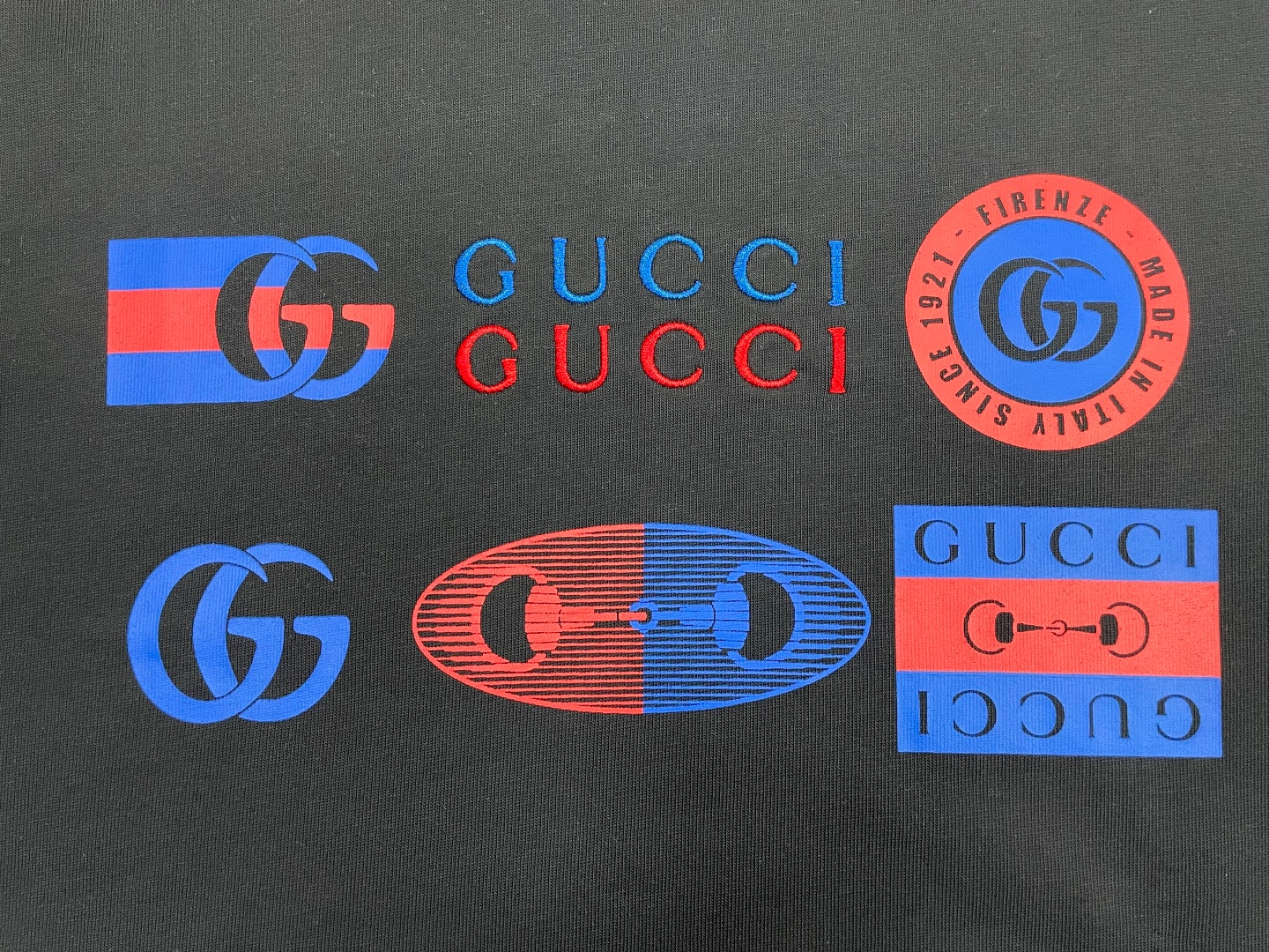 Dark Gucci T-shirt front with colorful logo graphics and GUCCI text