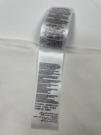 White T-shirt care label with printed washing and fabric instructions
