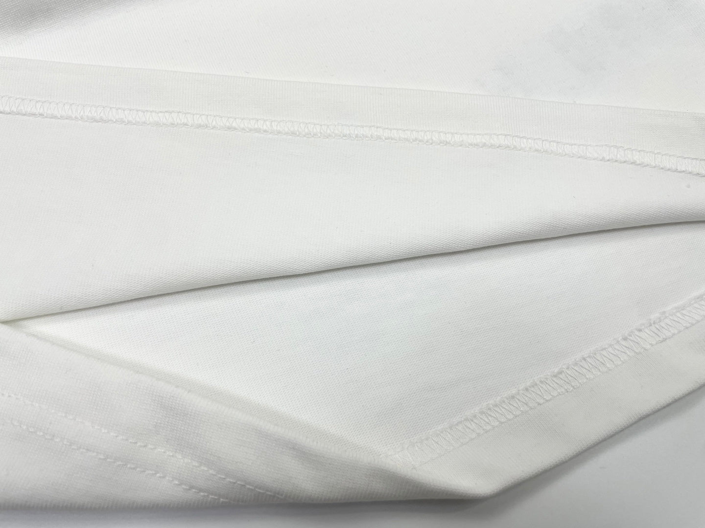 White T-shirt fabric fold with stitched hem edge
