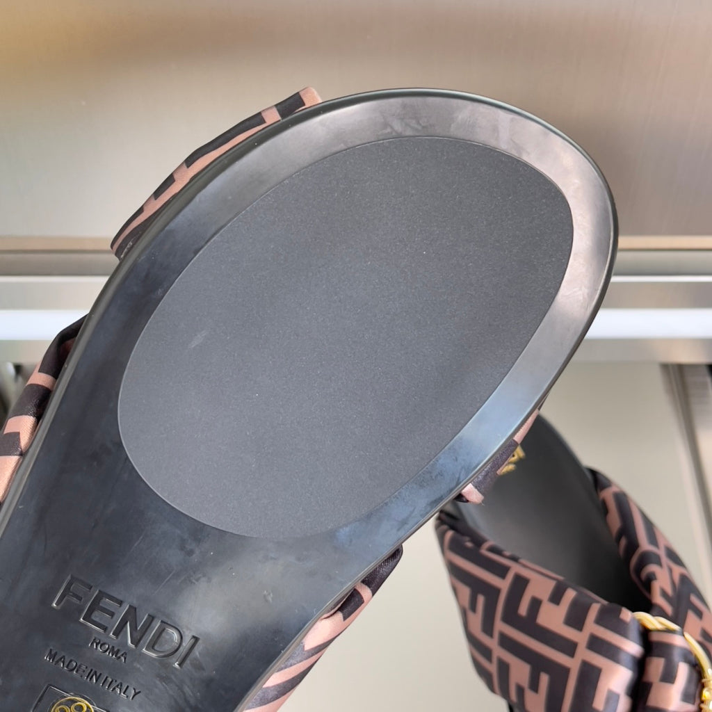 Fendi sandal outsole view with FF-pattern edge trim and gold hardware detail