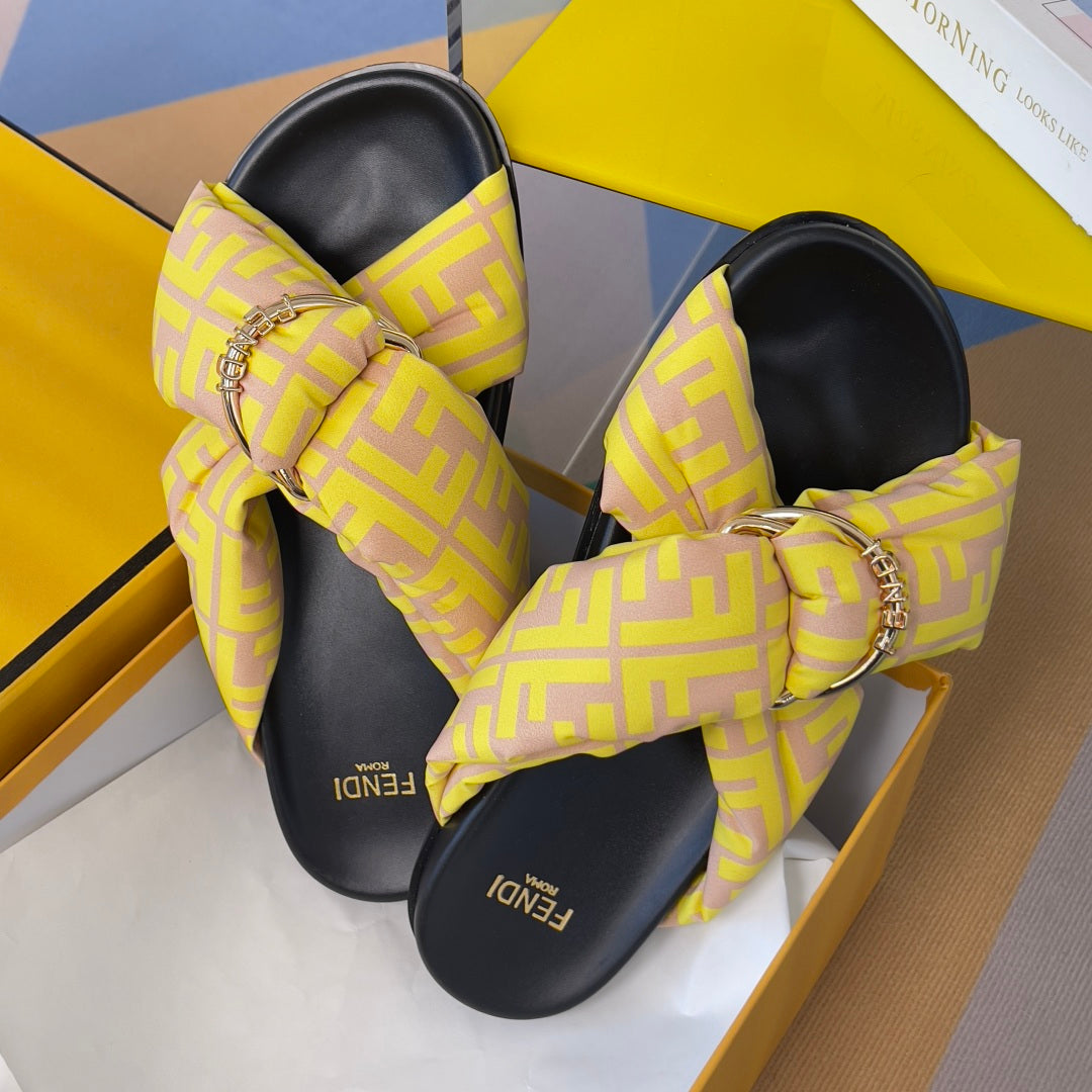 Fendi yellow logo slide sandals with knotted straps and gold-tone chain buckles
