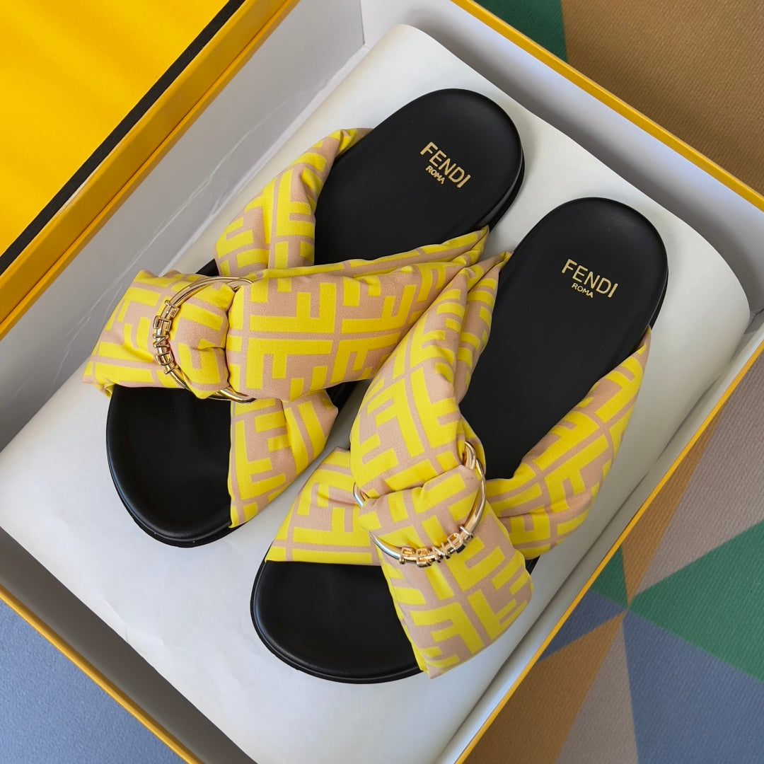 Fendi yellow patterned slide sandals with knotted bow strap and gold-tone chain buckle