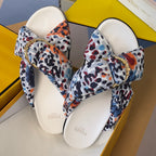 Fendi slide sandals with multicolor leopard-print straps and gold-tone buckle, two shoes shown