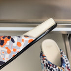 Fendi slide sandals showing black sole edge and multicolor leopard-print fabric strap