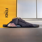 Dark navy Fendi slide sandals with floral bow strap and gold buckle detail