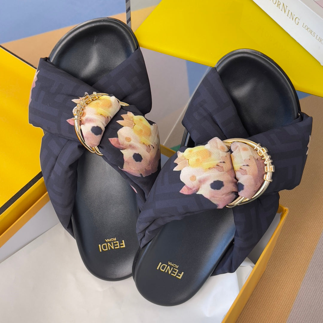 Dark navy Fendi slide sandals with floral bow straps, gold buckle on front