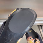 Dark navy Fendi slide sandals with black footbed and FENDI logo, gold accent