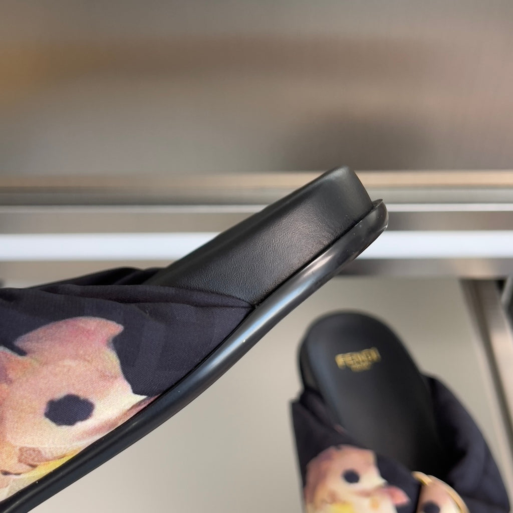 Dark navy slide sandal with floral fabric strap and smooth black leather sole