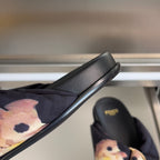 Dark navy slide sandal with floral fabric strap and smooth black leather sole