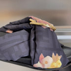 Dark navy slide sandal with floral bow detail and gold-tone buckle hardware