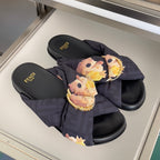 Dark navy Fendi slide sandals with floral fabric knot and gold ring buckle