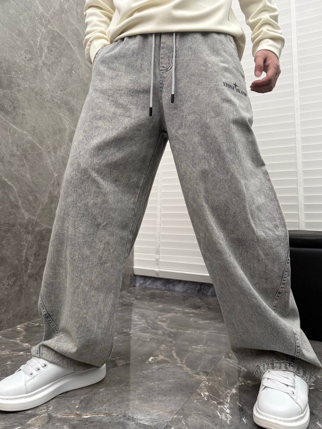 Grey stone-wash denim jogger pants with drawstring and side seam pockets