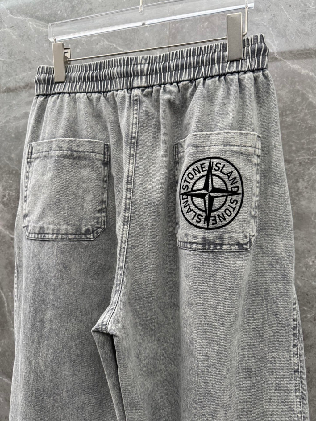 Grey denim jogger pants with logo patch pocket and drawstring waistband