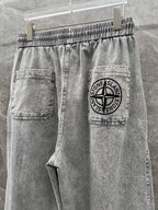 Grey denim jogger pants with logo patch pocket and drawstring waistband