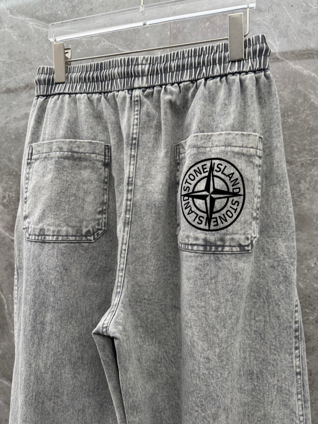 Grey denim jogger pants with logo patch pocket and drawstring waistband