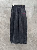 Wide-leg denim pants, dark wash, elastic waistband with drawstring; minimal front logo.