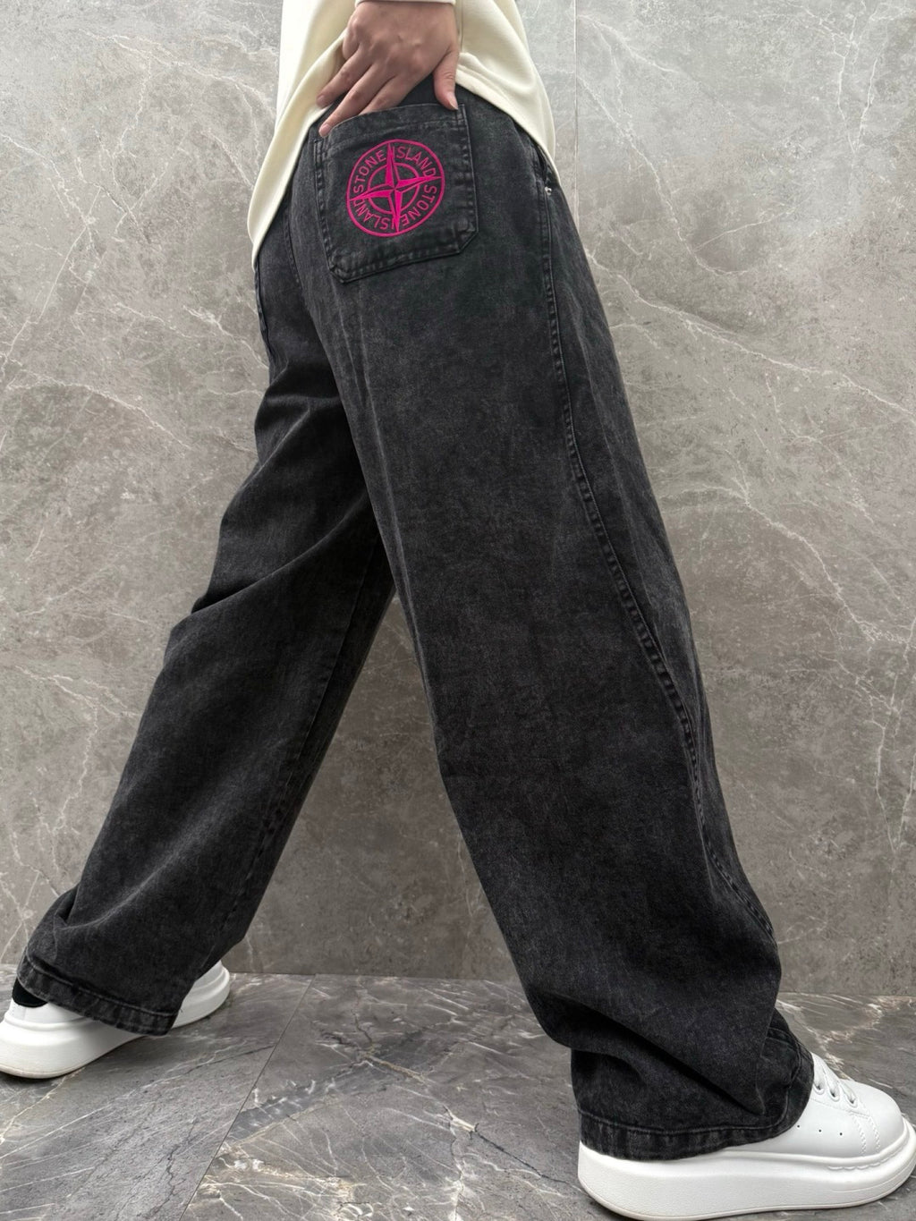 Wide-leg denim pants in dark wash with pink logo patch on side pocket.