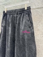 Wide-leg denim pants, washed gray, elastic waistband with drawstring; Stone Island logo print.