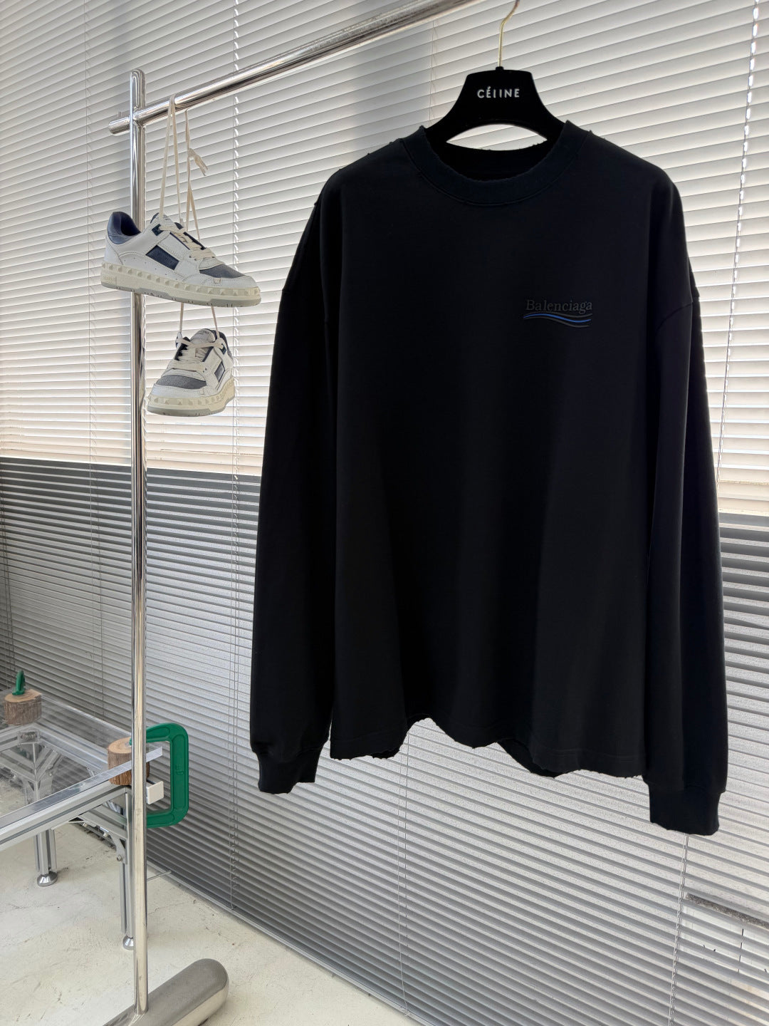 Balenciaga black crewneck long-sleeve sweatshirt on hanger