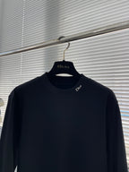 Navy Dior crew-neck long-sleeve shirt on hanger with small Dior logo at chest